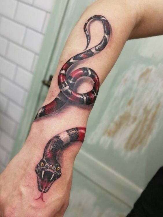 snake wrapped around arm tattoo